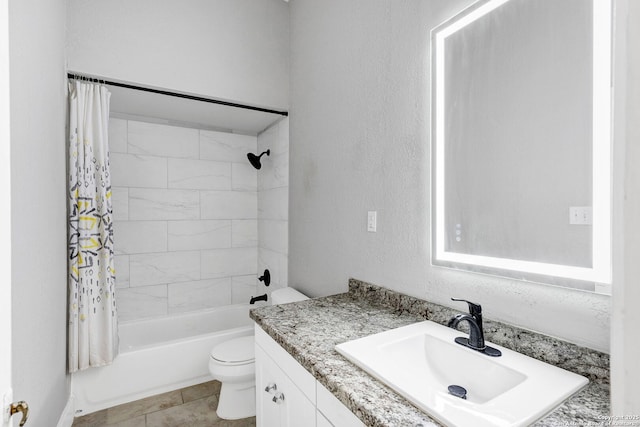 full bath featuring toilet, shower / tub combo, a textured wall, and vanity