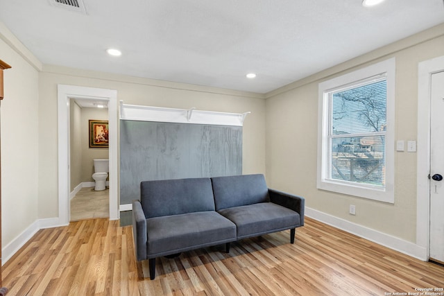 living area with light wood-type flooring, visible vents, baseboards, and recessed lighting