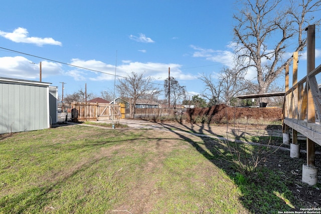 view of yard featuring a fenced backyard and an outbuilding