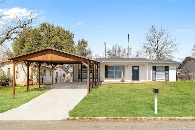 view of front of property featuring a carport, a front yard, concrete driveway, and brick siding