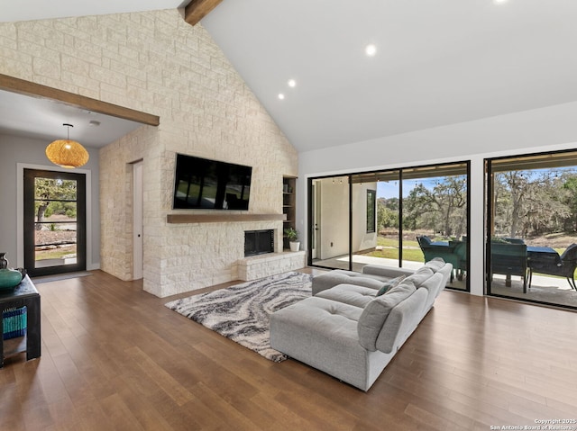 living room with a fireplace, wood finished floors, and a healthy amount of sunlight