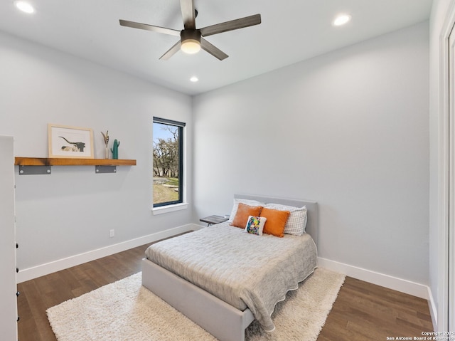 bedroom featuring baseboards, wood finished floors, and recessed lighting