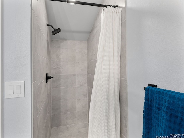 bathroom with a tile shower