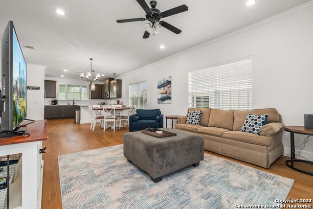 living room featuring ornamental molding, wood finished floors, and recessed lighting