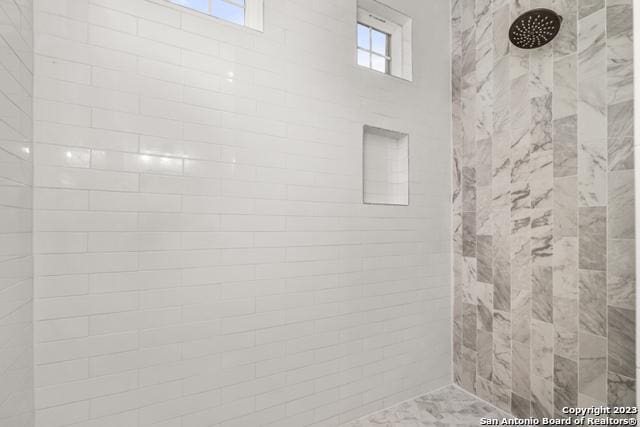 full bath featuring tiled shower