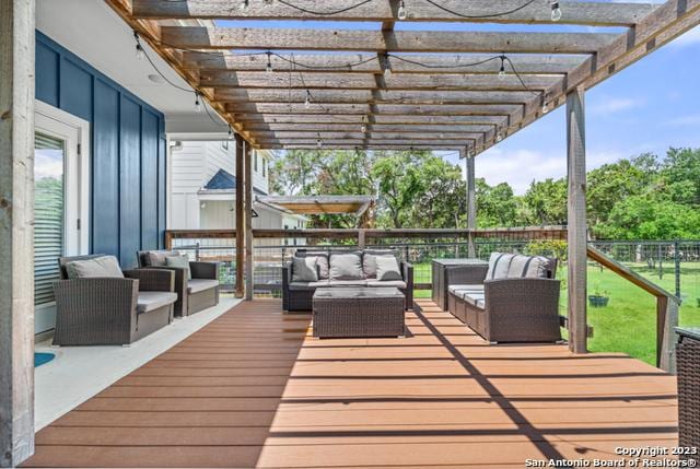 wooden terrace with a pergola and an outdoor hangout area