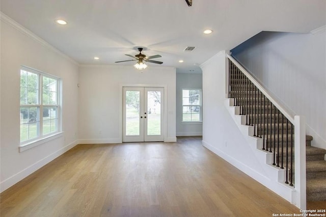 interior space featuring stairs, french doors, wood finished floors, and visible vents