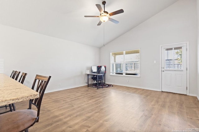 office featuring a healthy amount of sunlight, ceiling fan, baseboards, and wood finished floors