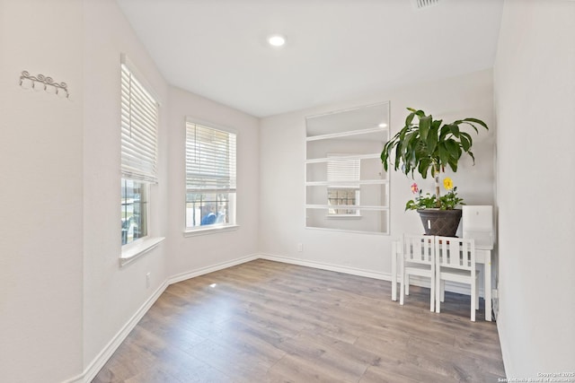 interior space featuring wood finished floors and baseboards