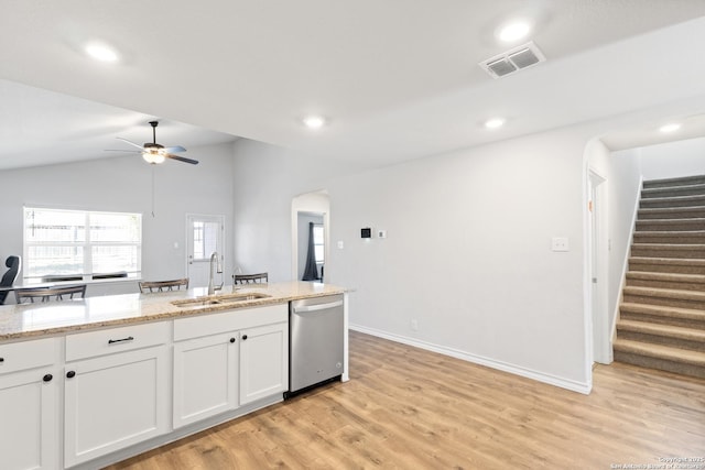 kitchen with arched walkways, a sink, visible vents, white cabinetry, and dishwasher