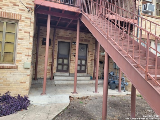 view of exterior entry featuring brick siding