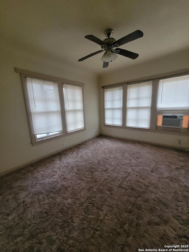 unfurnished room with a ceiling fan, carpet, cooling unit, and baseboards