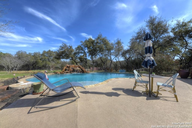 outdoor pool with a patio area