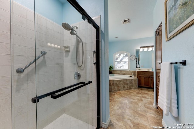 full bathroom with a bath, vanity, a shower stall, and visible vents