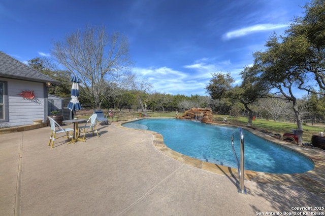 outdoor pool with a patio area