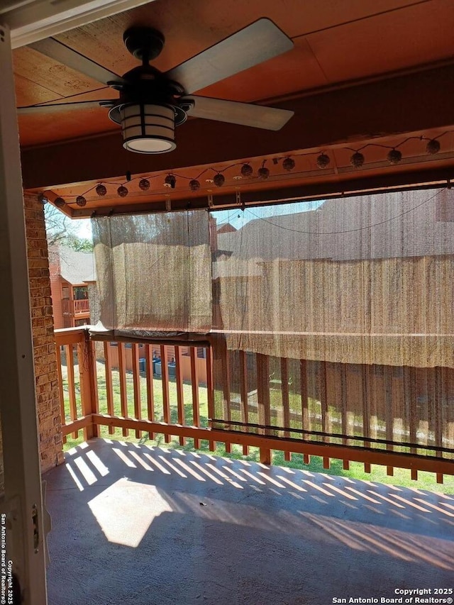 wooden terrace featuring a ceiling fan