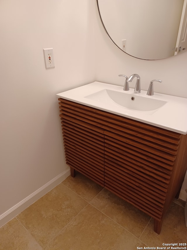 bathroom featuring vanity, baseboards, and tile patterned floors