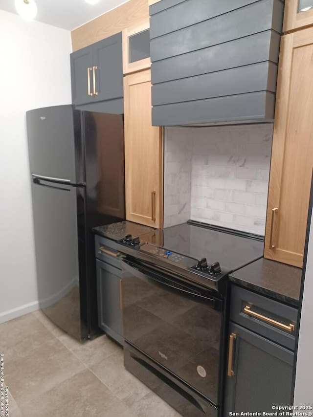 kitchen with light tile patterned floors, glass insert cabinets, ventilation hood, dark stone countertops, and black appliances