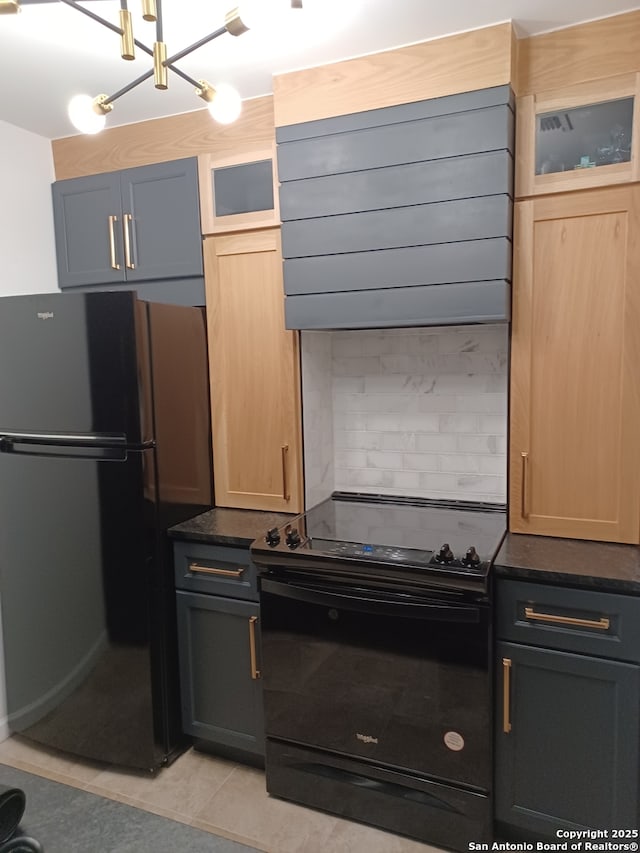 kitchen with light tile patterned floors, ventilation hood, decorative backsplash, black appliances, and glass insert cabinets