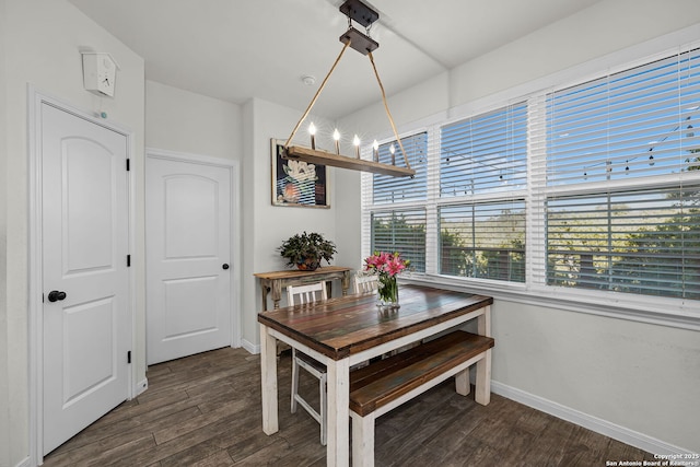 dining area with a chandelier, wood finished floors, and baseboards