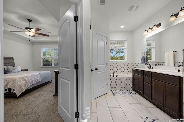 bathroom featuring a garden tub, connected bathroom, a sink, visible vents, and double vanity