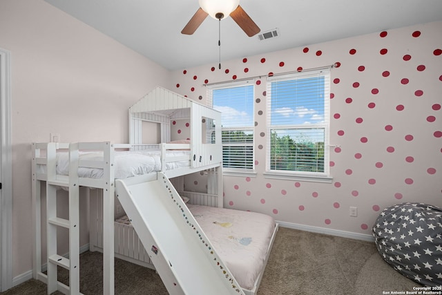 unfurnished bedroom featuring wallpapered walls, carpet, visible vents, and baseboards