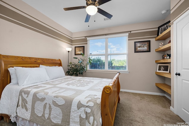 carpeted bedroom featuring ceiling fan, visible vents, and baseboards