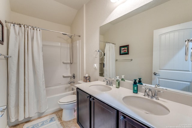 full bath featuring tile patterned flooring, a sink, shower / tub combo, and toilet