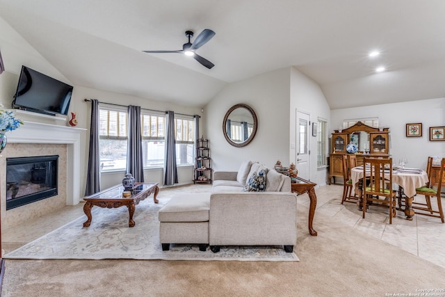 living room with lofted ceiling, carpet flooring, a high end fireplace, and tile patterned floors