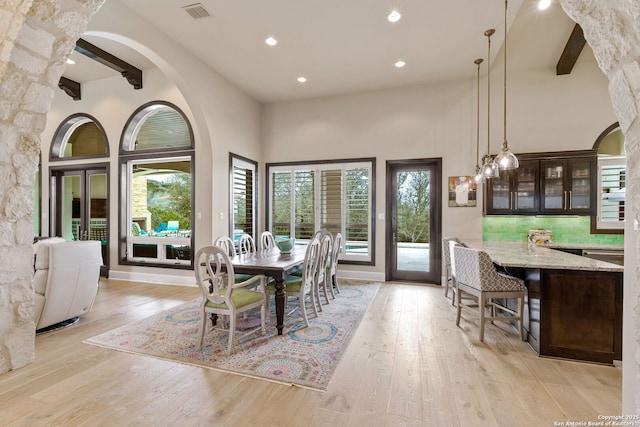 dining area featuring a wealth of natural light, light wood finished floors, and visible vents