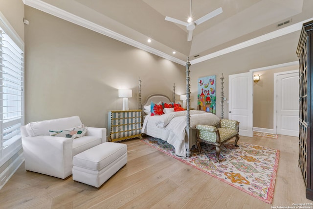 bedroom featuring crown molding, visible vents, a towering ceiling, a ceiling fan, and light wood-type flooring