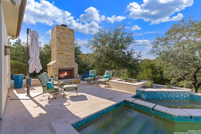 view of patio with an outdoor stone fireplace