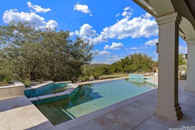 pool featuring a patio and a jacuzzi