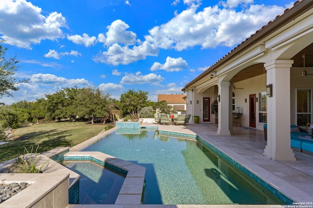 view of pool featuring outdoor dining space, a pool with connected hot tub, a patio area, and an outdoor hangout area