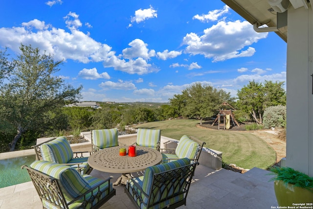 view of patio / terrace with outdoor dining area and a playground