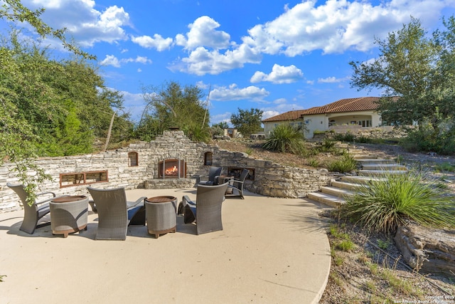 view of patio / terrace with an outdoor stone fireplace