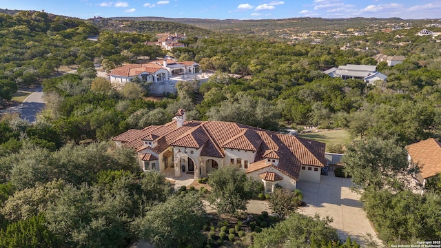 birds eye view of property featuring a view of trees