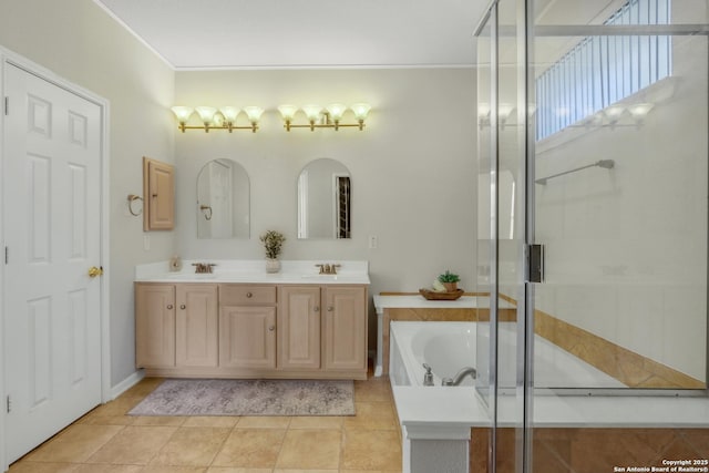 full bath with double vanity, a garden tub, a shower stall, and a sink