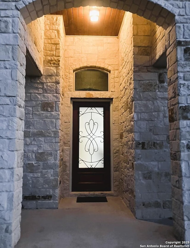 entrance to property with stone siding