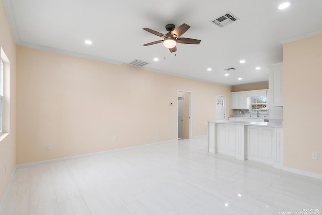 unfurnished living room with recessed lighting, visible vents, baseboards, and ornamental molding