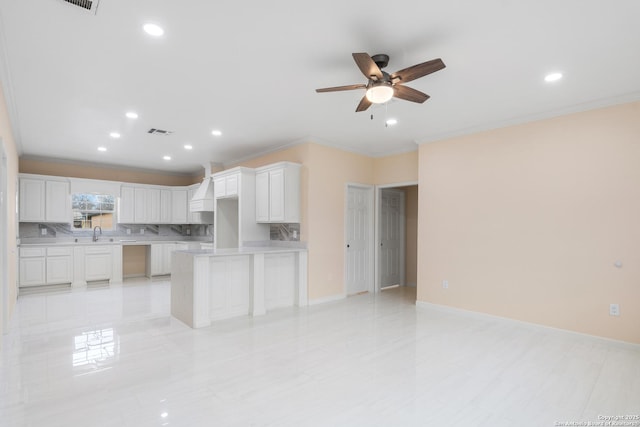 kitchen featuring light countertops, visible vents, decorative backsplash, and white cabinetry