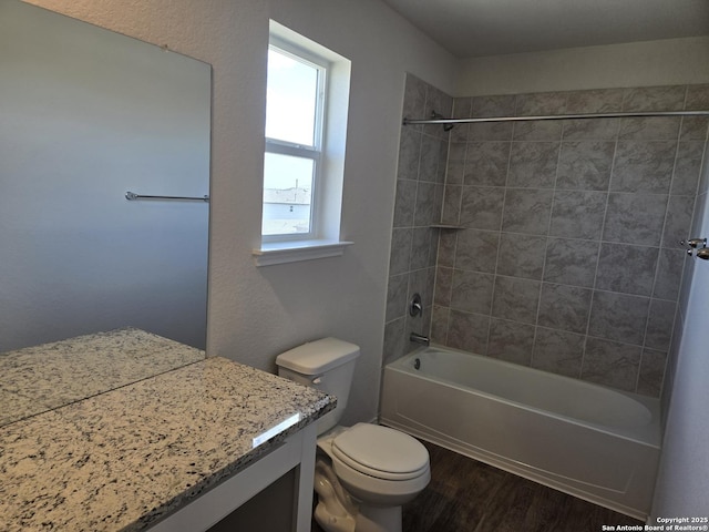 full bath with toilet, tub / shower combination, wood finished floors, and vanity