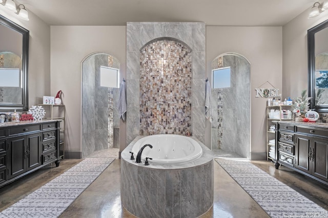 full bathroom with a healthy amount of sunlight, finished concrete flooring, and a whirlpool tub