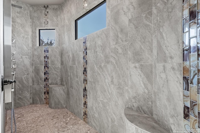 bathroom with a wealth of natural light and tiled shower