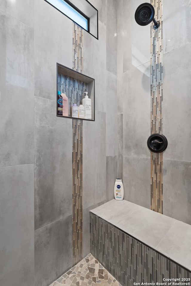 bathroom with a tile shower