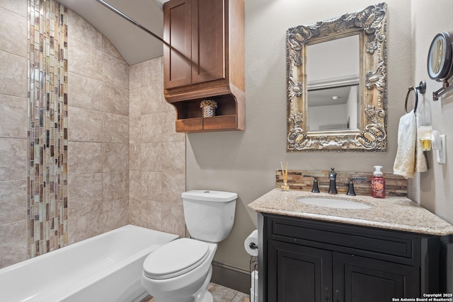 bathroom with toilet, baseboards, shower / bathing tub combination, and vanity