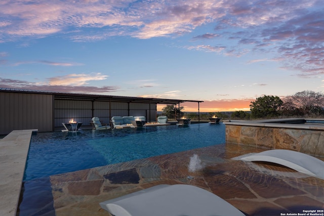 view of pool at dusk