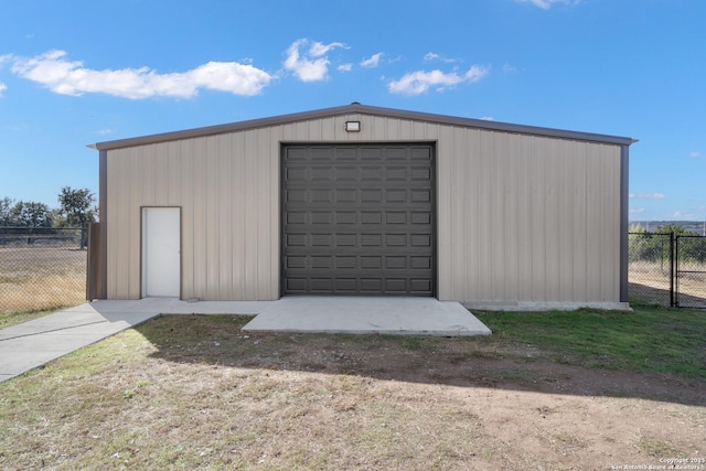 detached garage featuring fence