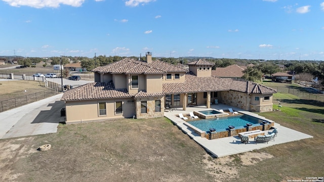 exterior space featuring a patio, a yard, a tiled roof, stucco siding, and a chimney