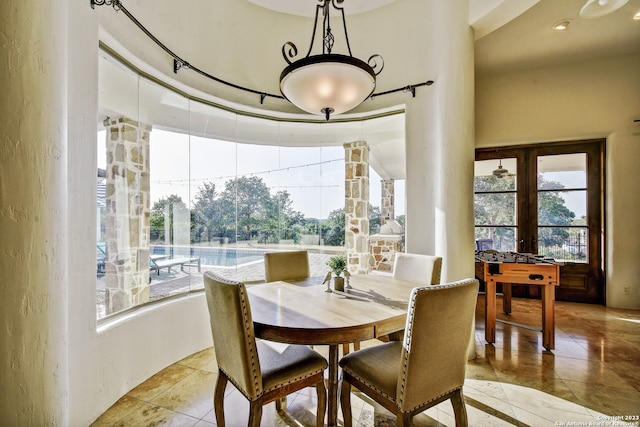 dining space featuring french doors and light tile patterned flooring